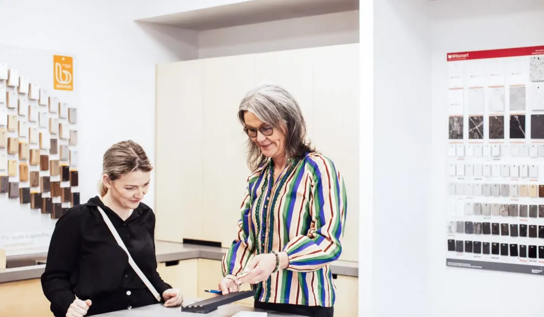 Kitchen designer and client selecting materials, benchtops and cabinet finishes during design consultation for Wellington renovation