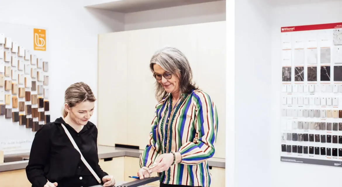 Kitchen designer and client selecting materials, benchtops and cabinet finishes during design consultation for Wellington renovation