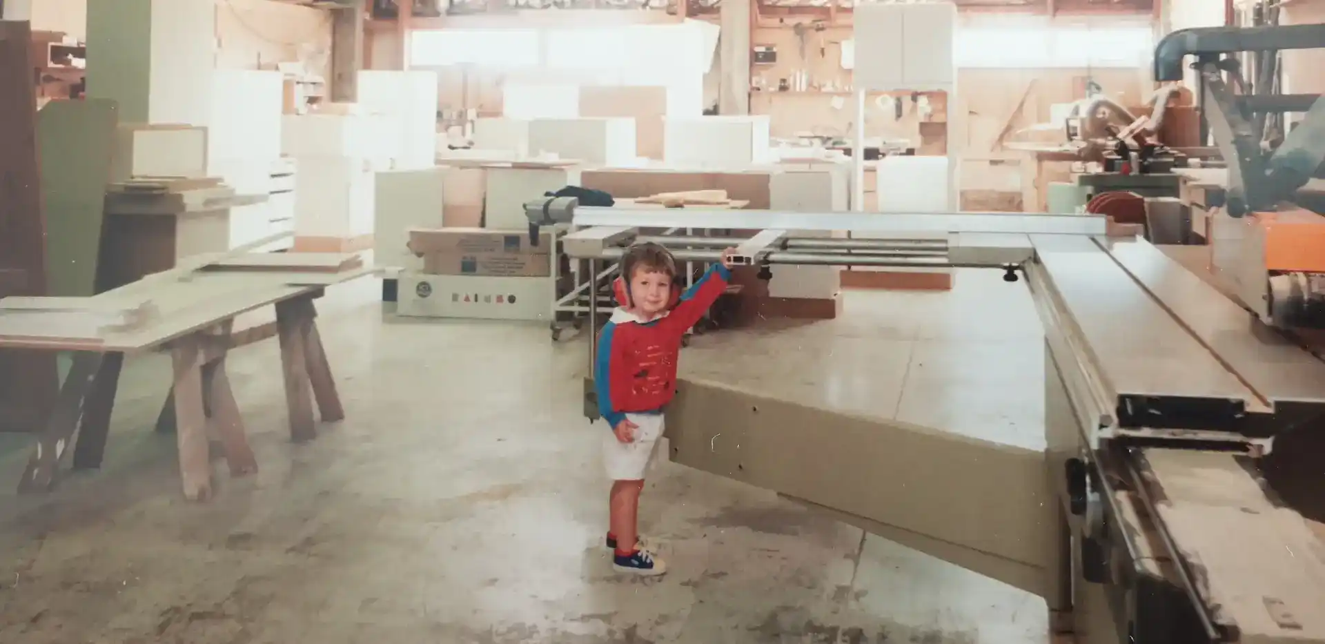 Young Justin Williams as a child in his father Gareth Williams' original Chatswood Kitchens workshop in the 1980s