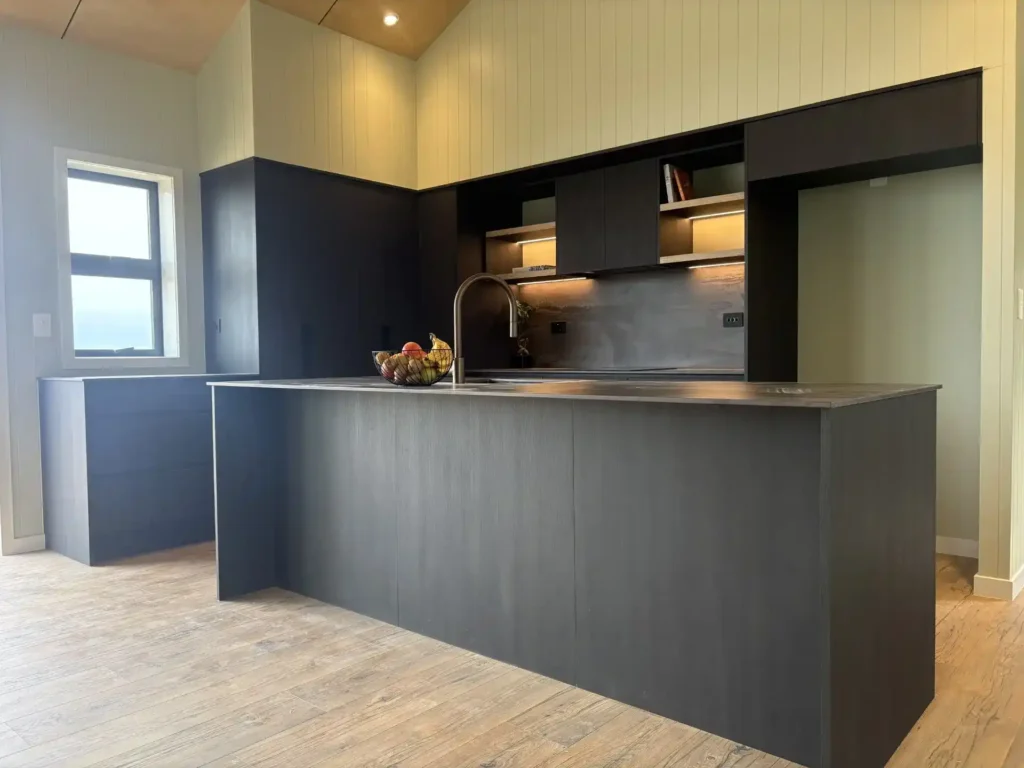 Kitchen designer Waikanae contemporary new build featuring dark matte cabinetry, waterfall island and coastal views