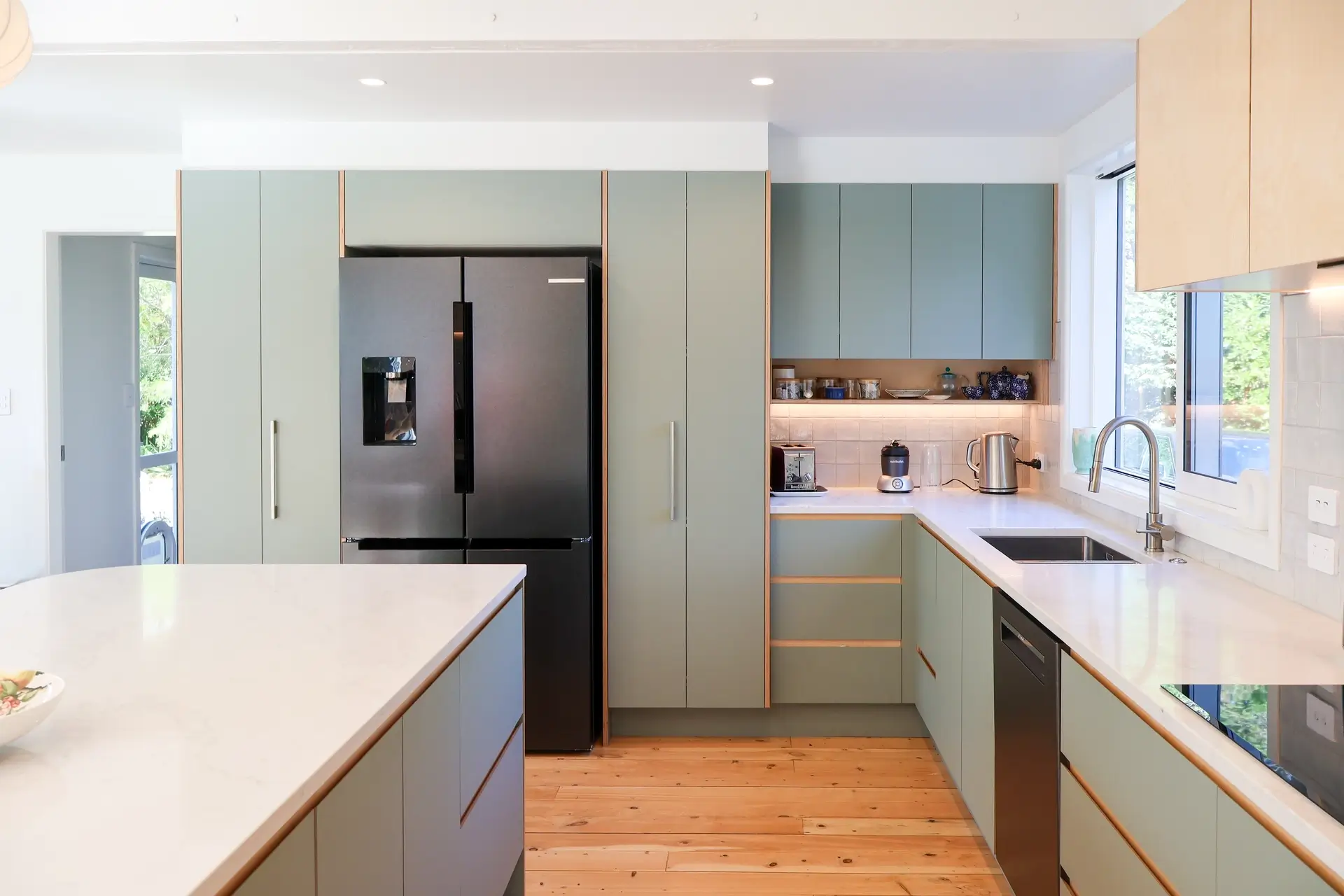 Modern kitchen design Paraparaumu showroom featuring custom sage doors cabinetry and coastal styling
